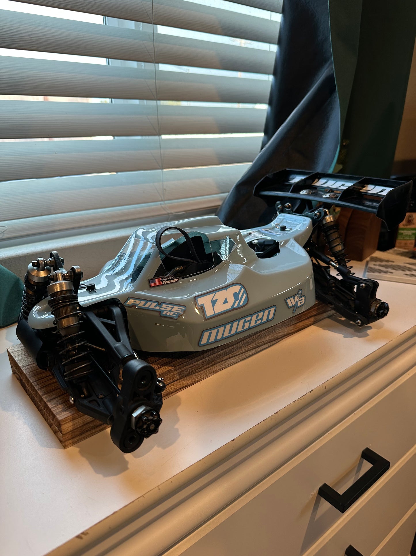 RC buggy with sponsor decals displayed on a table