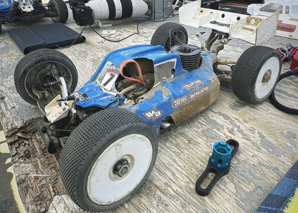 Blue RC buggy at a pit table