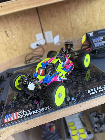 RC buggy displayed on a personalized pit board with a simulated forged carbon design